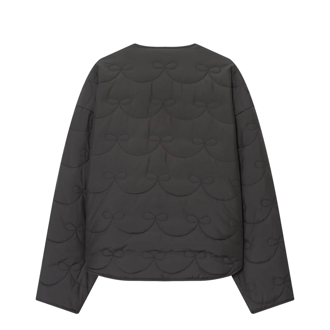 Dam vadderad kort jacka med bow quiltning och round neckline