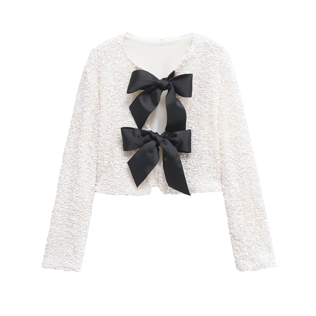 Dam sequin bolero jacka med double bow closure, vadderad foder och figurnära cropped skärning
